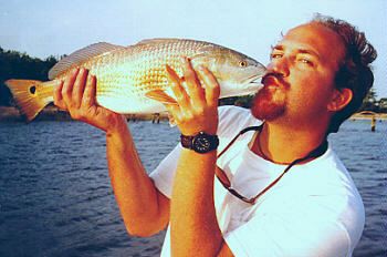 Captain J.R. Waits kissing redfish family fishing

trips